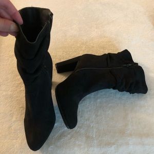 Closed toe calf length heeled booties.